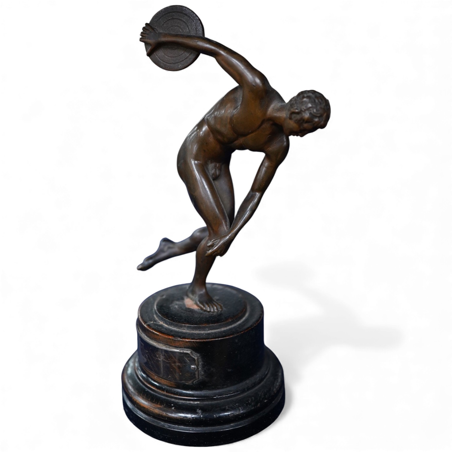 A bronze study of a classical discus thrower with silver mounted plaque to the base, 17cm high